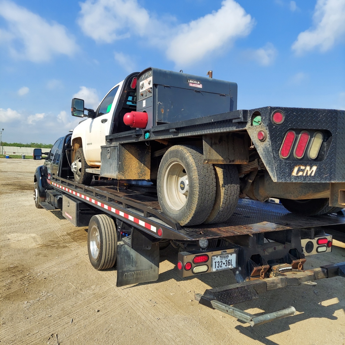 All City Towing flatbed loaded with a work truck, San Antonio, TX